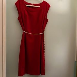 Red Jones New York collection stretch sheath dress with gold chain belt.